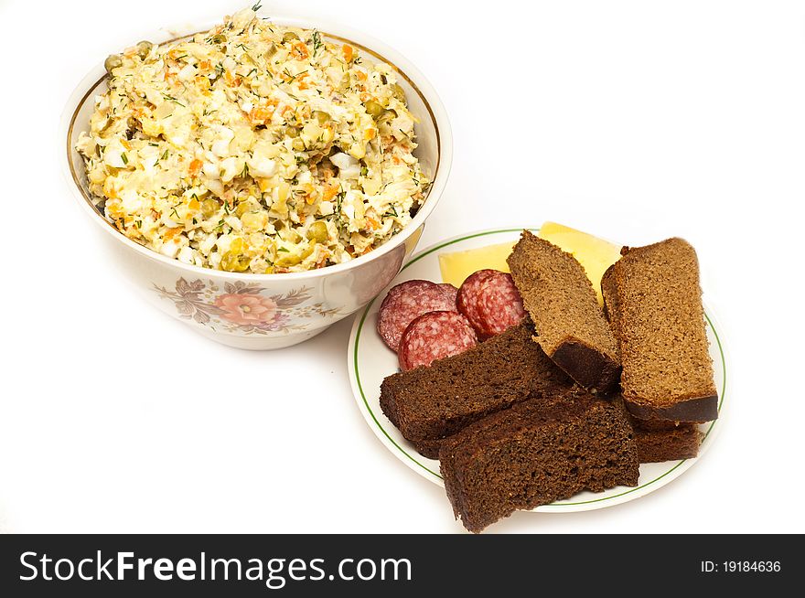 Russian salad olivie served with bread isolated on white background