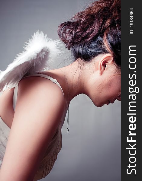 Girl wearing a white top with wings. Girl wearing a white top with wings.