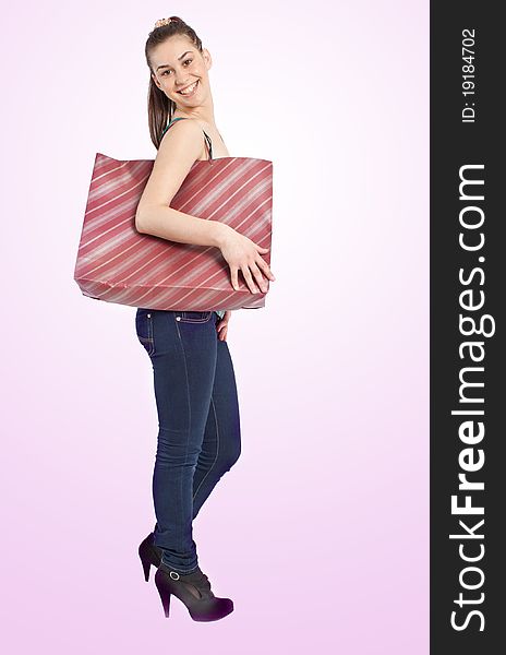 Beautiful girl with shopping bag over pink background. Beautiful girl with shopping bag over pink background