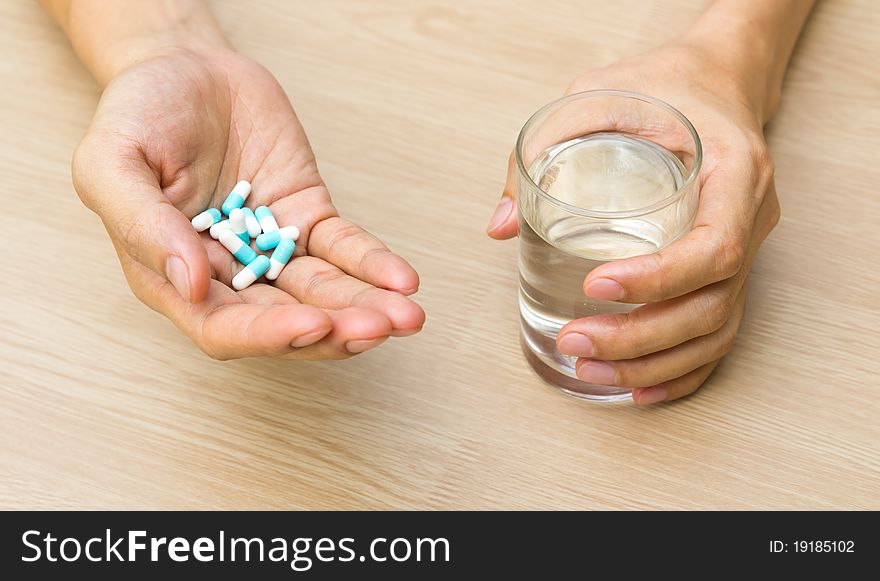 Tablet and a glass of water in hands. Tablet and a glass of water in hands