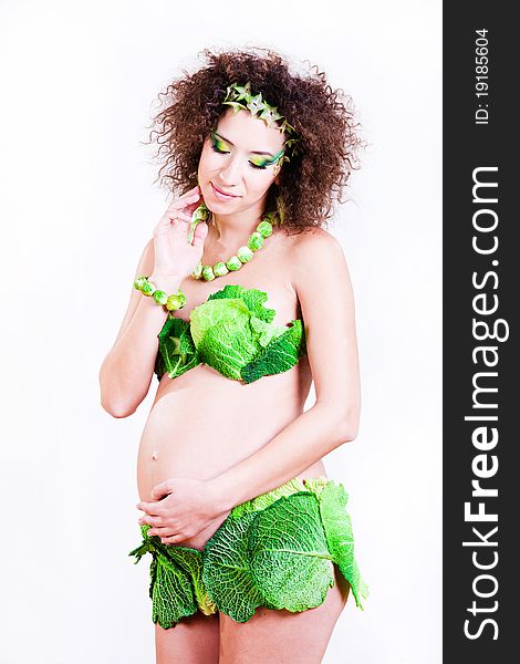 Beautiful pregnant young woman dressed in cabbage