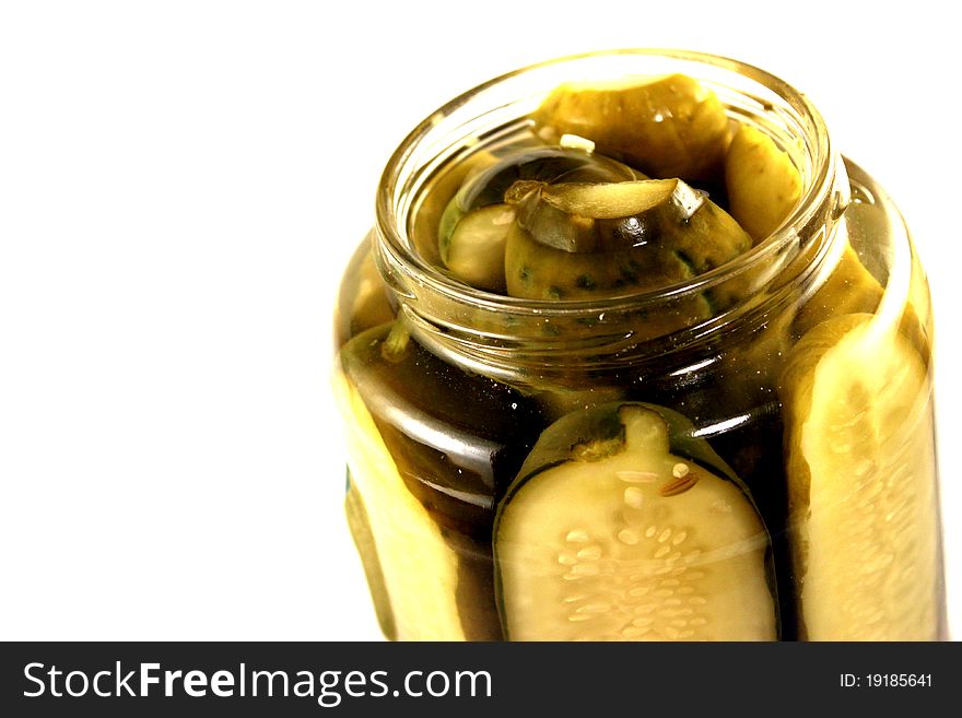 Close-up of a jar of pickles on a white background