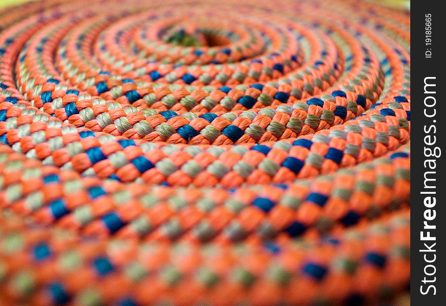 A climbing rope coiled in decreasing circles. Bright colours and selective. A climbing rope coiled in decreasing circles. Bright colours and selective.