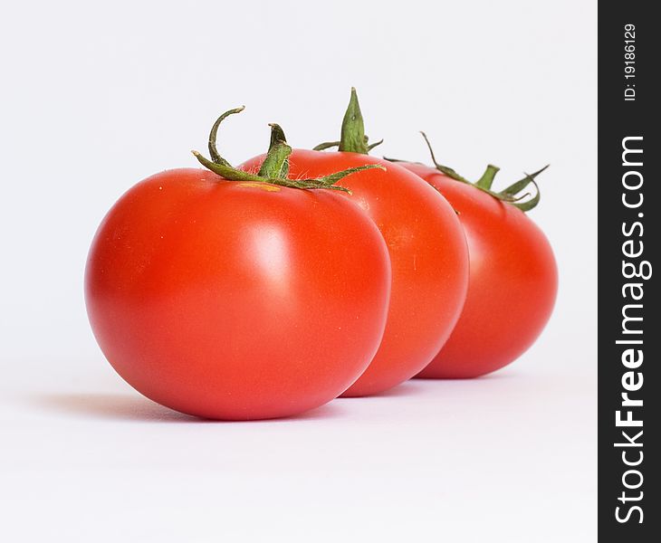 Three fresh tomatoes isolated on white background. Three fresh tomatoes isolated on white background