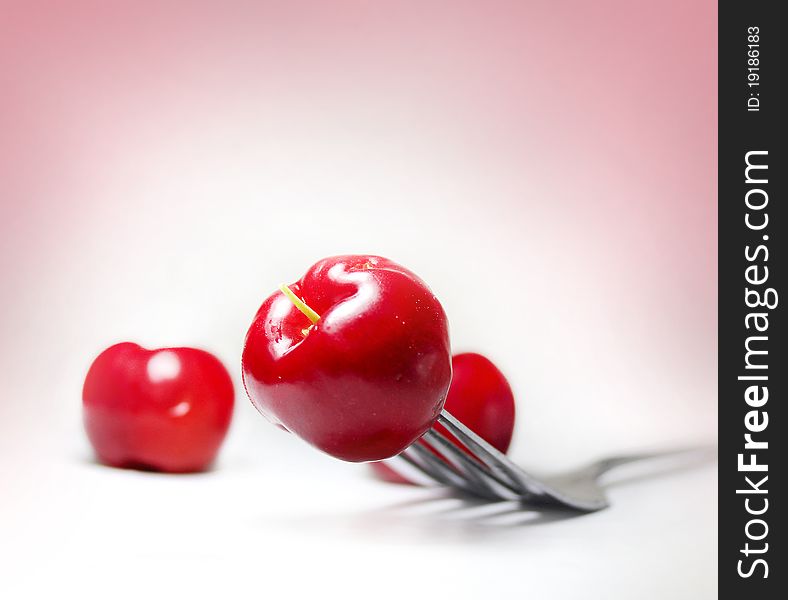 Macro image of cherry on fork