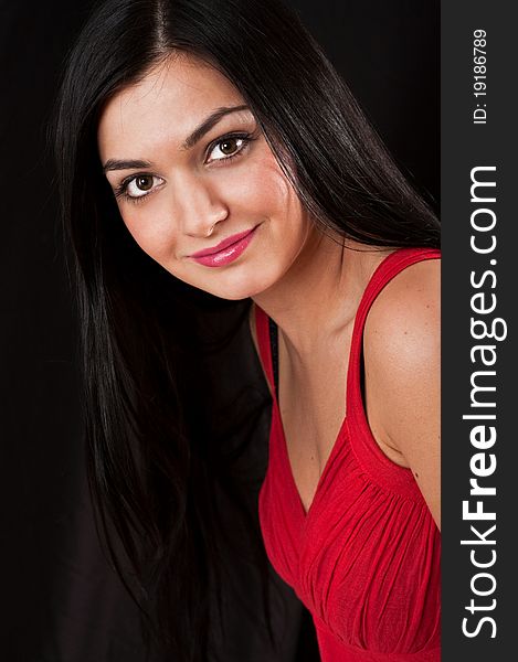 Portrait of young pretty woman in red dress