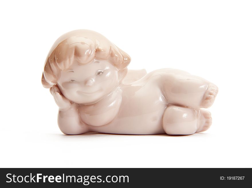 Figurine of an angel pink lies on a white background. isolated. Figurine of an angel pink lies on a white background. isolated