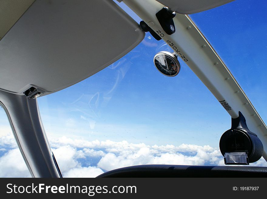 A shot of clouds and blue sky taken from a cockpit of a light aircraft at 5000 feet. A shot of clouds and blue sky taken from a cockpit of a light aircraft at 5000 feet.