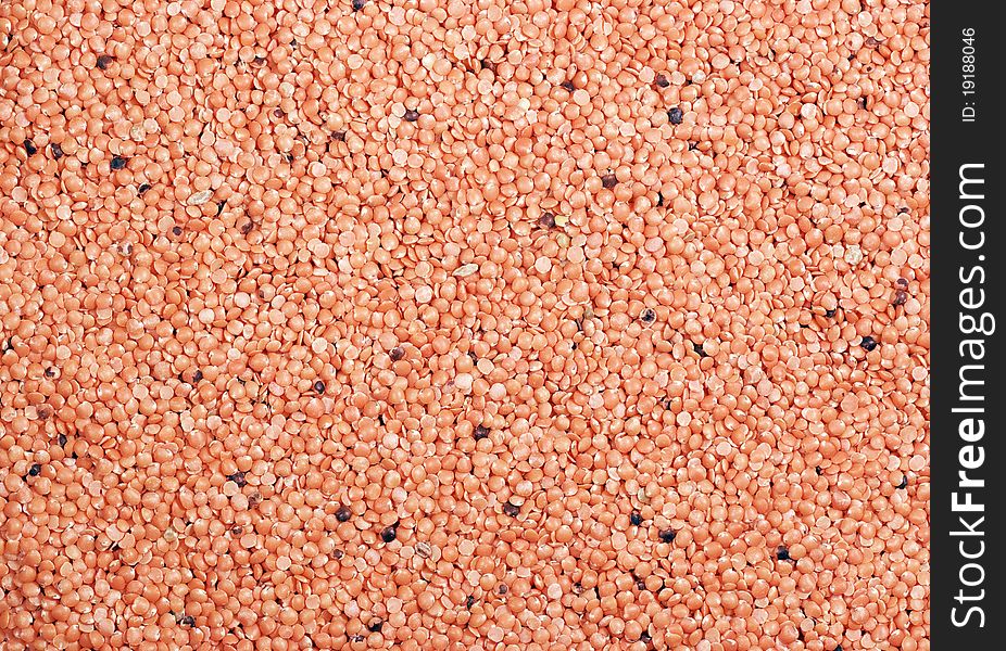 A background of red lentils