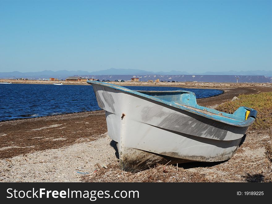 Fishing boat on the beach, camp in the back ground. Fishing boat on the beach, camp in the back ground