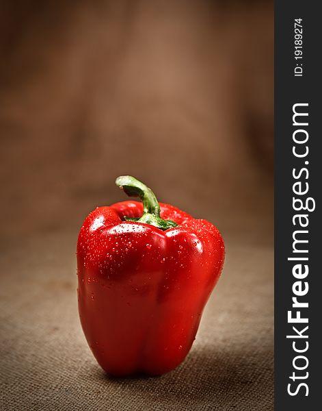 Fresh red pepper on sacking background