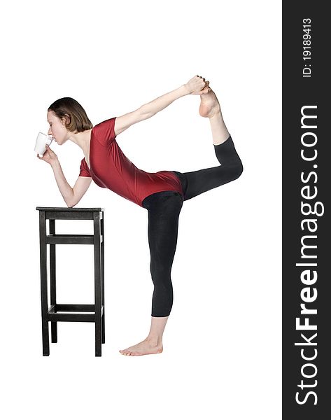 Slim woman drinking tea and stretching at the same time. Slim woman drinking tea and stretching at the same time