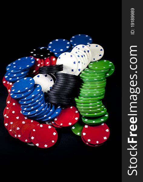 A lot of poker chips on a black background