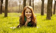 Beautiful Girl Sitting At Green Grass At Park. Stock Images Beautiful Girl Sitting At Green Grass At Park. Stock Images