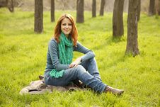Beautiful Girl Sitting At Green Grass At Park. Royalty Free Stock Photos Beautiful Girl Sitting At Green Grass At Park. Royalty Free Stock Photos