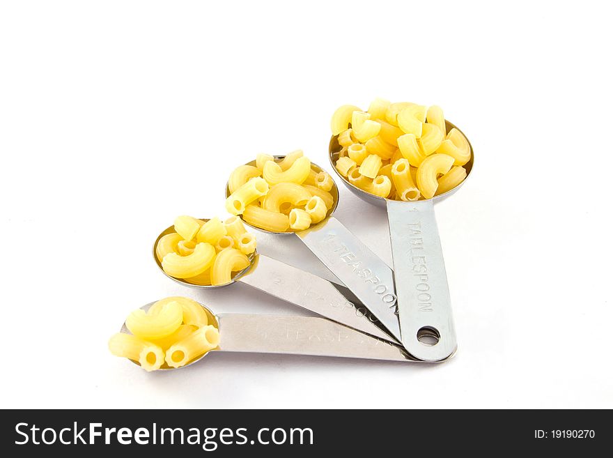 Macaroni measure spoon on white background