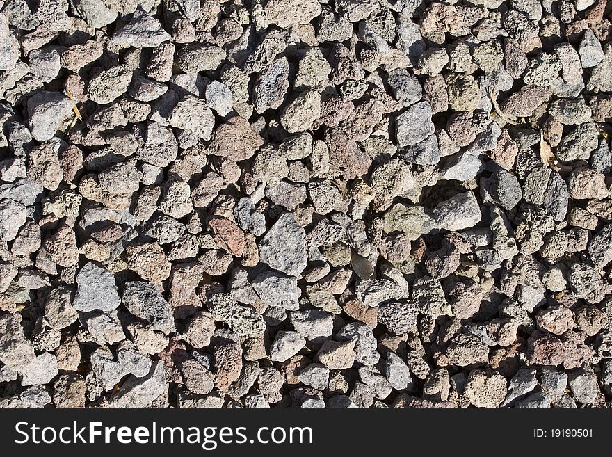 Crushed lava rocks in one flower bed. Crushed lava rocks in one flower bed