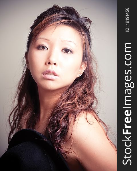 Asian young woman in black fashion shoot.