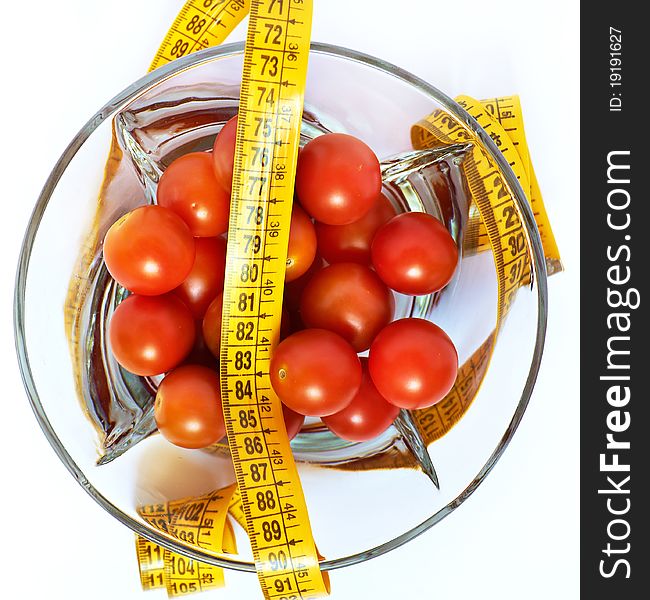 Tomatoes with measuring tape as losing weight concept isolated. Tomatoes with measuring tape as losing weight concept isolated