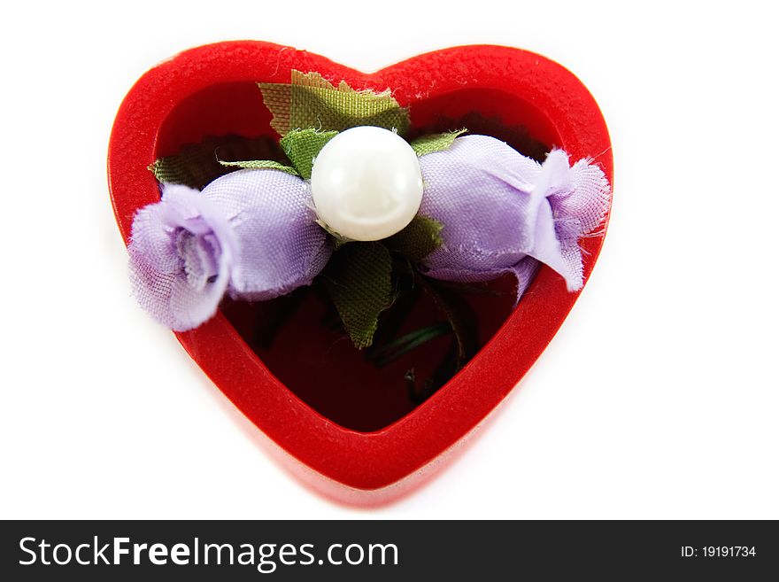 Heart in which artificial flowers isolated on white background