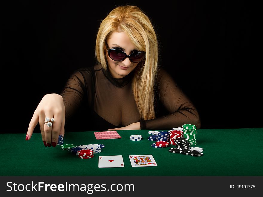 Sexy Blond Playing Poker on a green table