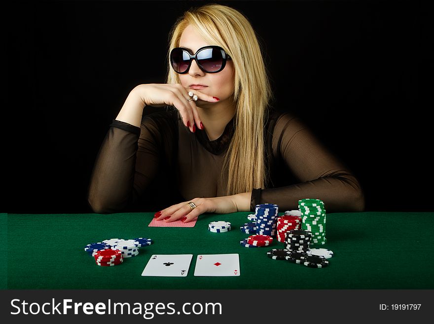 Blond Playing Poker on a green table. Blond Playing Poker on a green table