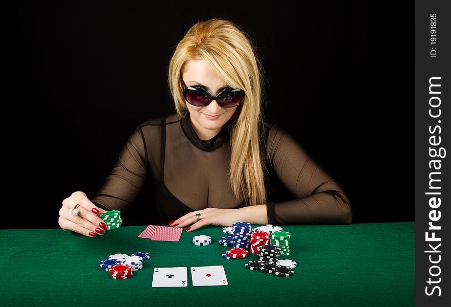 Blond Playing Poker on a green table. Blond Playing Poker on a green table