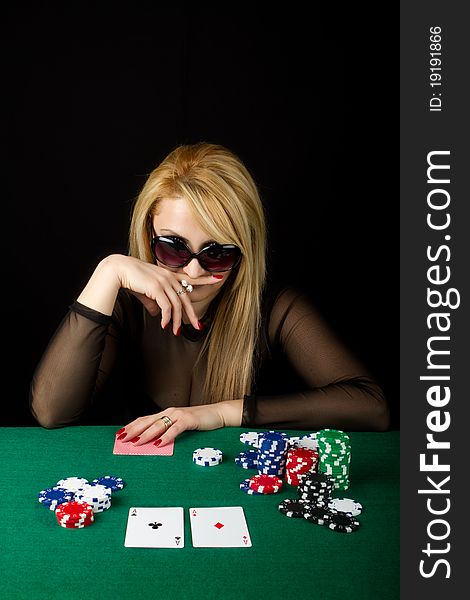 Blond Playing Poker on a green table. Blond Playing Poker on a green table