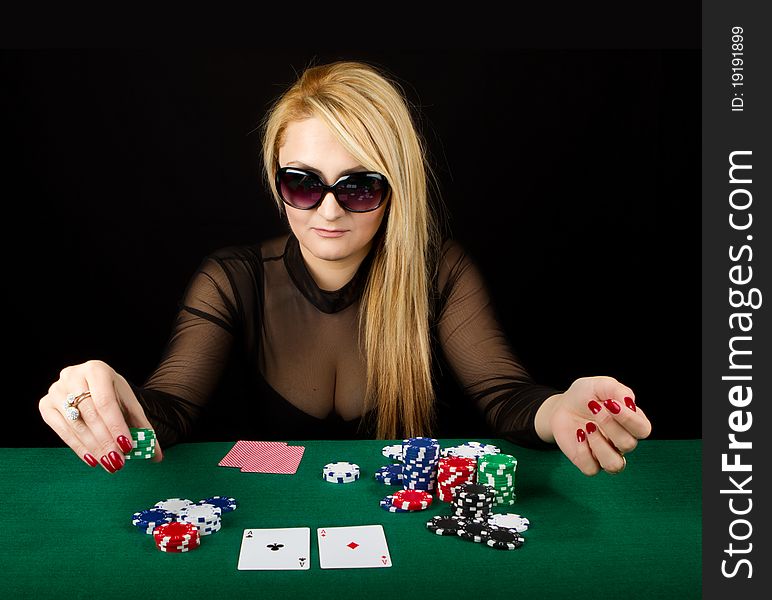 Sexy Blond Playing Poker on a green table