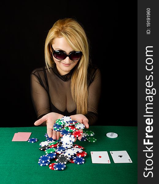 Sexy Blond Playing Poker on a green table