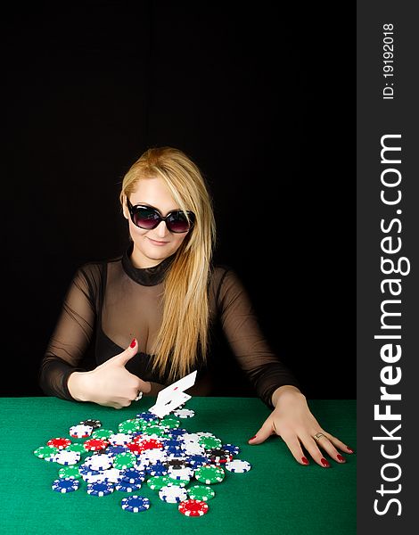 Sexy Blond Playing Poker on a green table