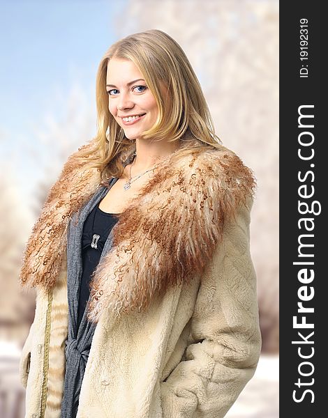 Portrait of a beautiful woman in the fur coat