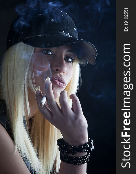 Young pretty girl is smoking cigarette
