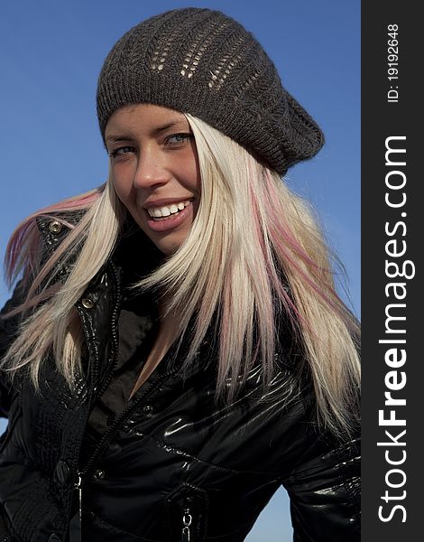 Beautiful young woman under blue sky. Portrait