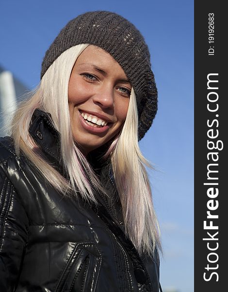 Beautiful young woman under blue sky