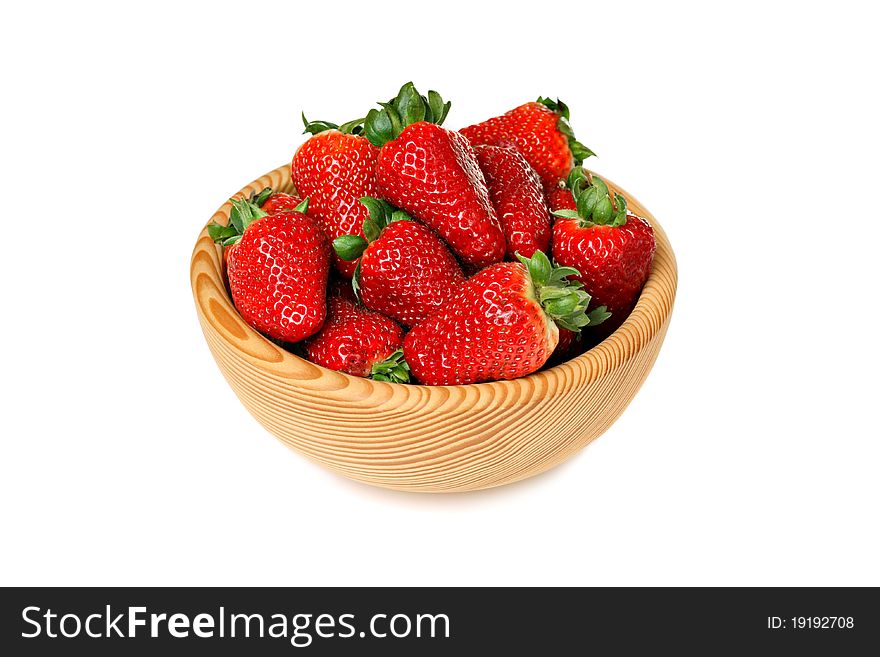 Strawberries in wooden bowl, isolated on white