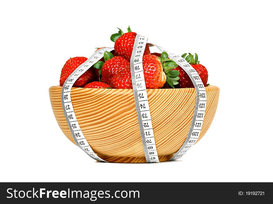 Strawberries in wooden bowl with measuring tape, isolated on white