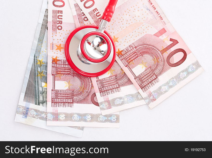 Red stethoscope is over euro money background. Red stethoscope is over euro money background.
