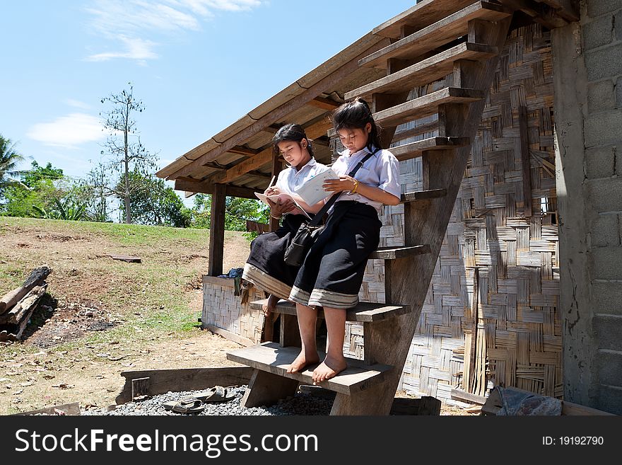 Asian students learning, teenager in school uniform in front of their house