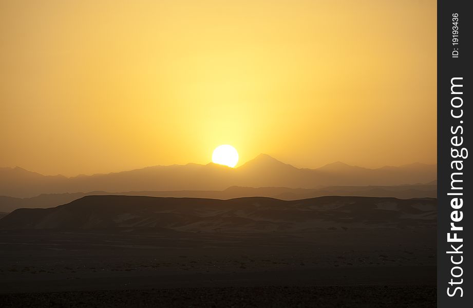 Desert Sunset Over The Mountains