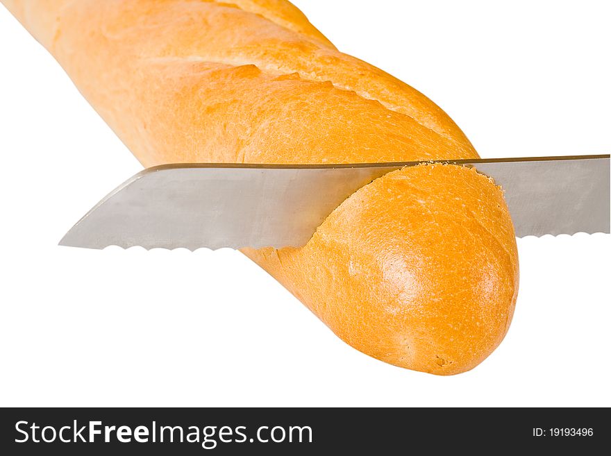 The grain knife cuts the French baguet. The grain knife cuts the French baguet