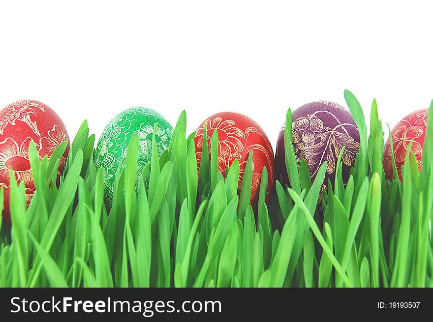 Traditional scratched hand-made Easter eggs on a grass