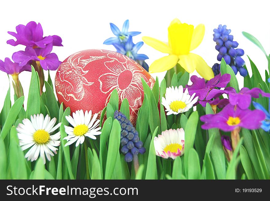 Traditional scratched hand-made Easter egg on a spring meadow