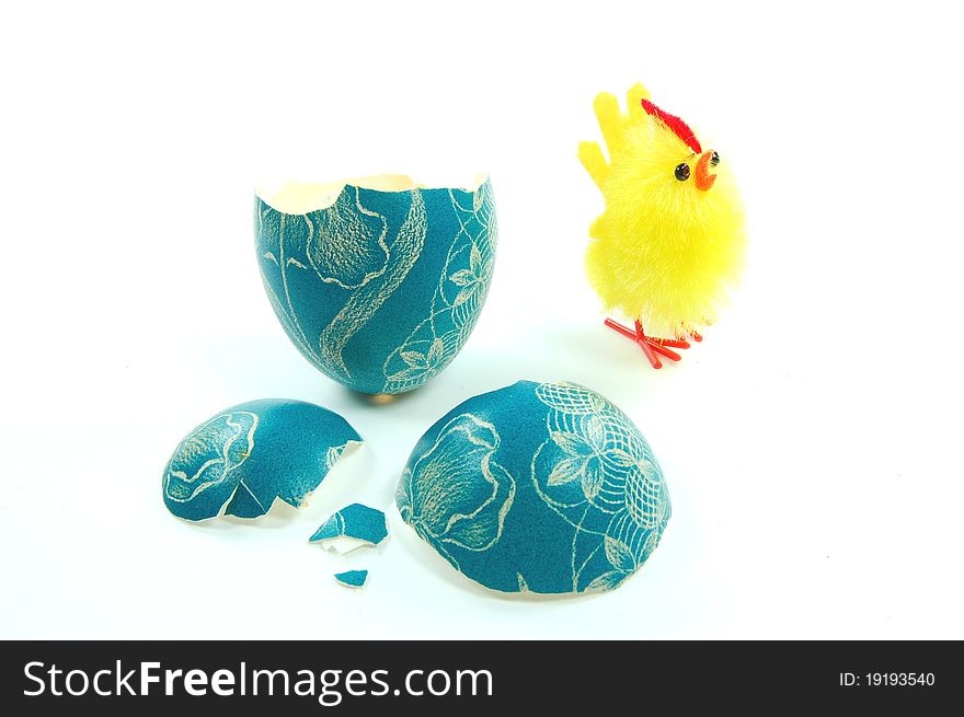 Easter chicken and broken Easter egg isolated on white