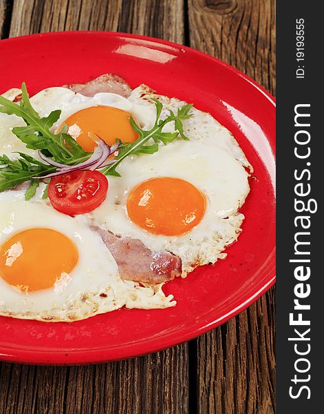 Fried eggs with slices of bacon - sunny side up. Fried eggs with slices of bacon - sunny side up
