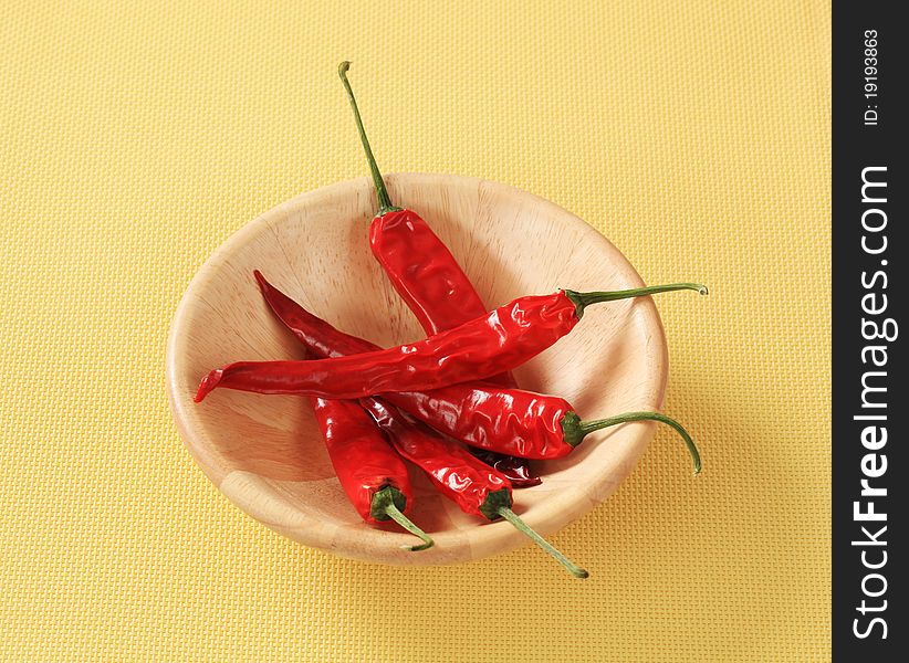 Red chili peppers in a wooden bowl