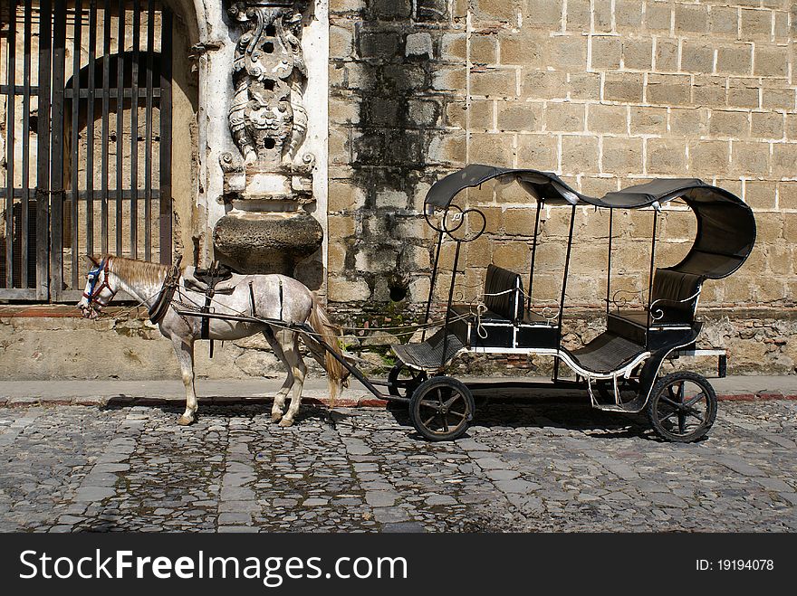 An old-style horse-drawn carriage in Antigua, Guatemala. An old-style horse-drawn carriage in Antigua, Guatemala