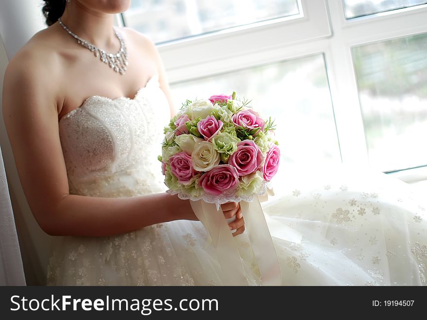 A beautiful bride at wedding. She is Holding flowers. A beautiful bride at wedding. She is Holding flowers