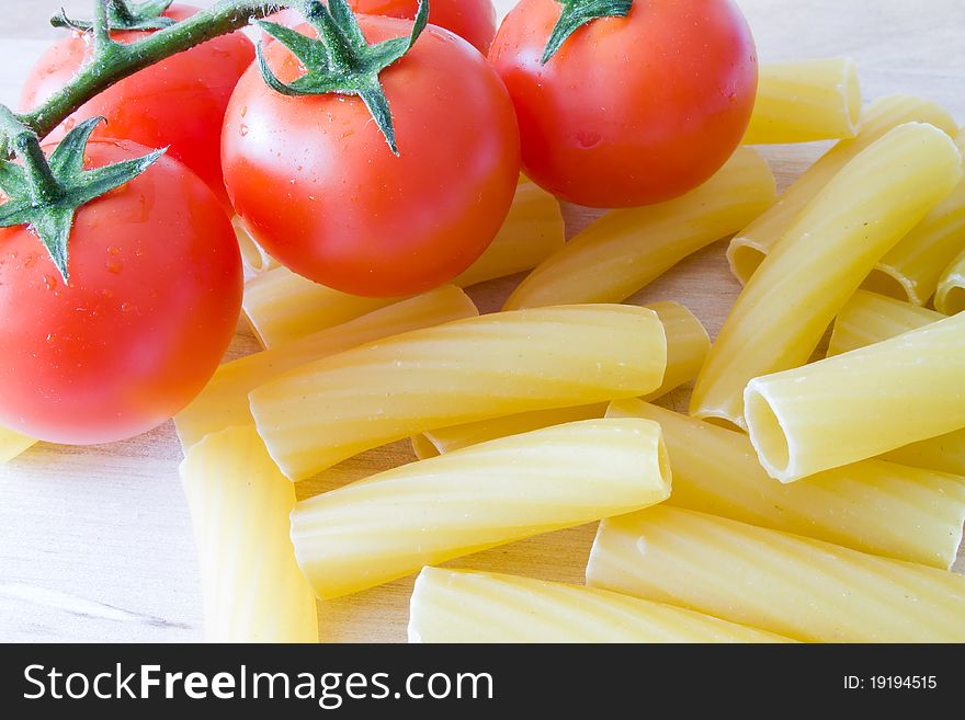 Italian raw pasta with little red tomato. Italian raw pasta with little red tomato