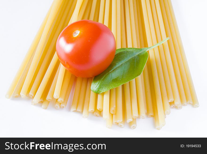 Italian raw pasta with tomato and basil. Italian raw pasta with tomato and basil